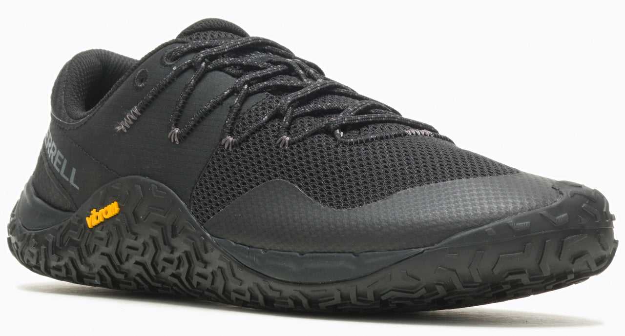 A black athletic shoe with dark laces and a yellow logo.