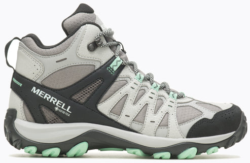 Hiking boot, mostly gray with black and light green accents, featuring a mid-height design and lace-up closure; the side has "MERRELL" and "GORE-TEX" visible.