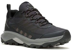 A black low-top athletic shoe with a thick gray lug sole, lace-up closure, and a fabric upper with overlapping dark gray stripes.