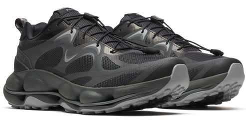 A pair of dark gray running shoes with black laces and a unique bubble-like sole.