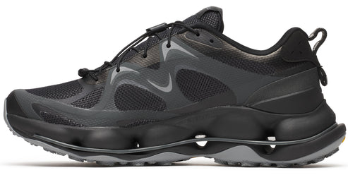 Side view of a black running shoe with a unique sole design featuring bubble-like protrusions and a quick-lace system.