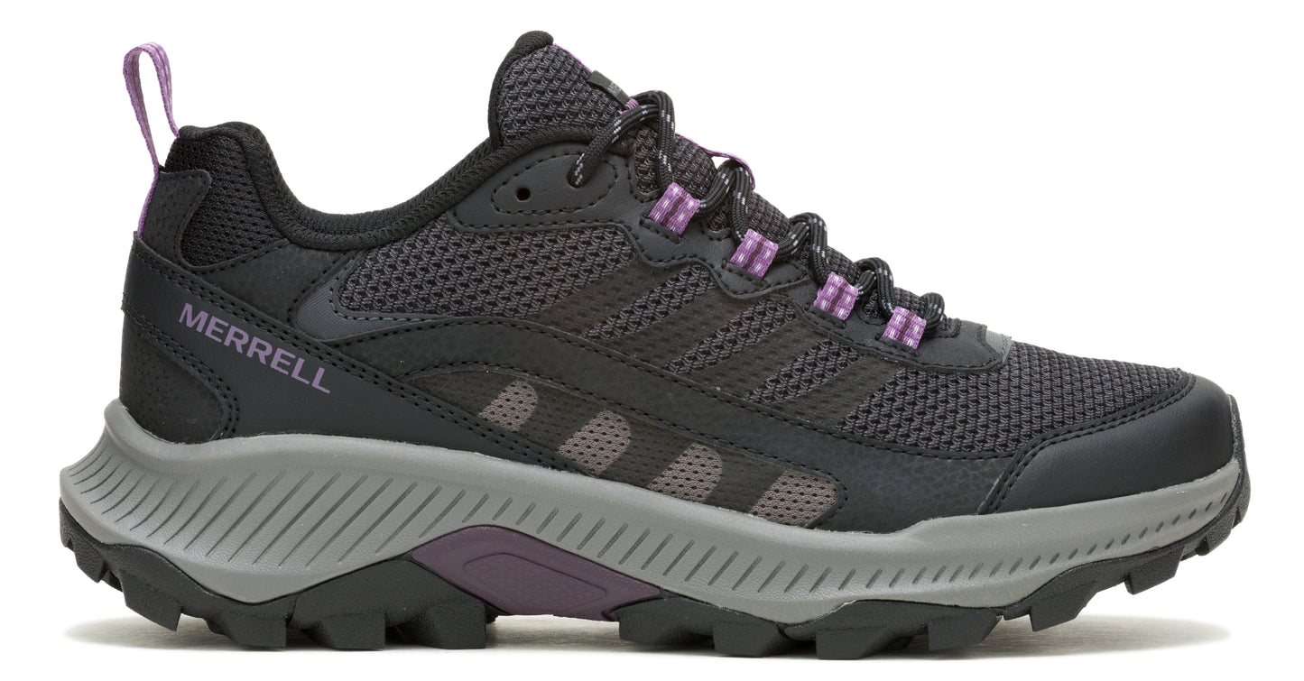 A black hiking shoe with gray sole and purple accents, showcasing a mesh upper and lugged outsole.