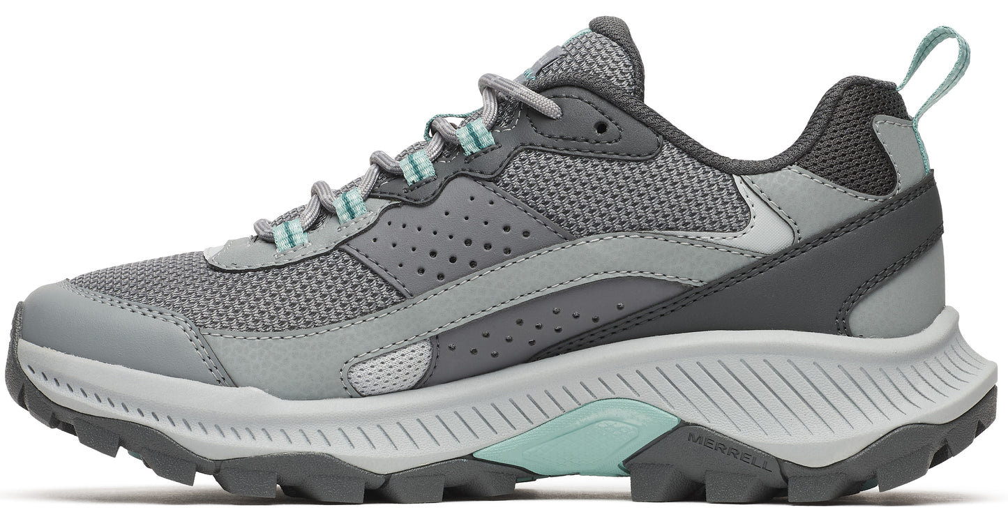 Gray sneaker with teal accents and a thick, jagged sole.