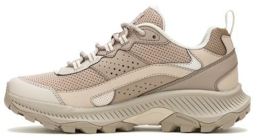 Beige athletic shoe with mesh upper and lugged outsole.