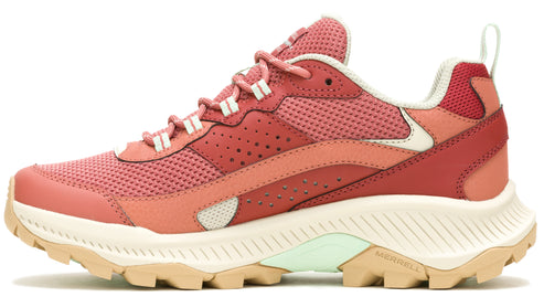 A pink and red hiking shoe with cream colored soles.