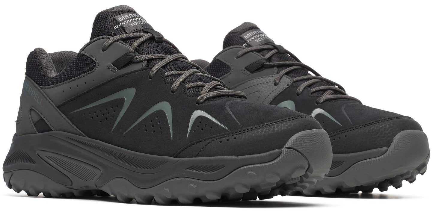 A pair of dark gray athletic shoes featuring lace-up closure and low-profile design.