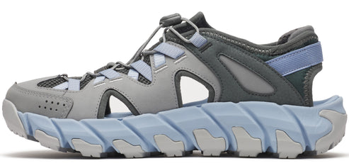A sandal with a gray upper and a light blue lug sole.
