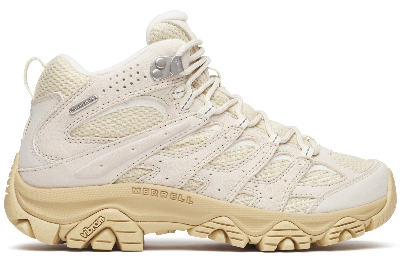Beige hiking boot with vibram sole and 'Merrell' printed near the sole.