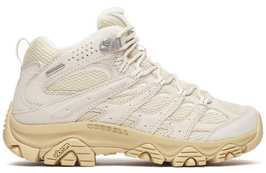 Beige hiking boot with vibram sole and 'Merrell' printed near the sole.