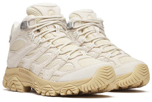 Beige high-top hiking boots with beige laces and soles.
