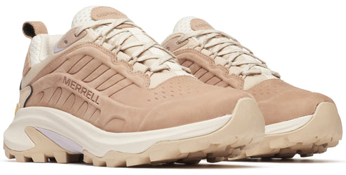 Two tan hiking sneakers with off-white laces and white midsole, with 'MERRELL' written on the side.