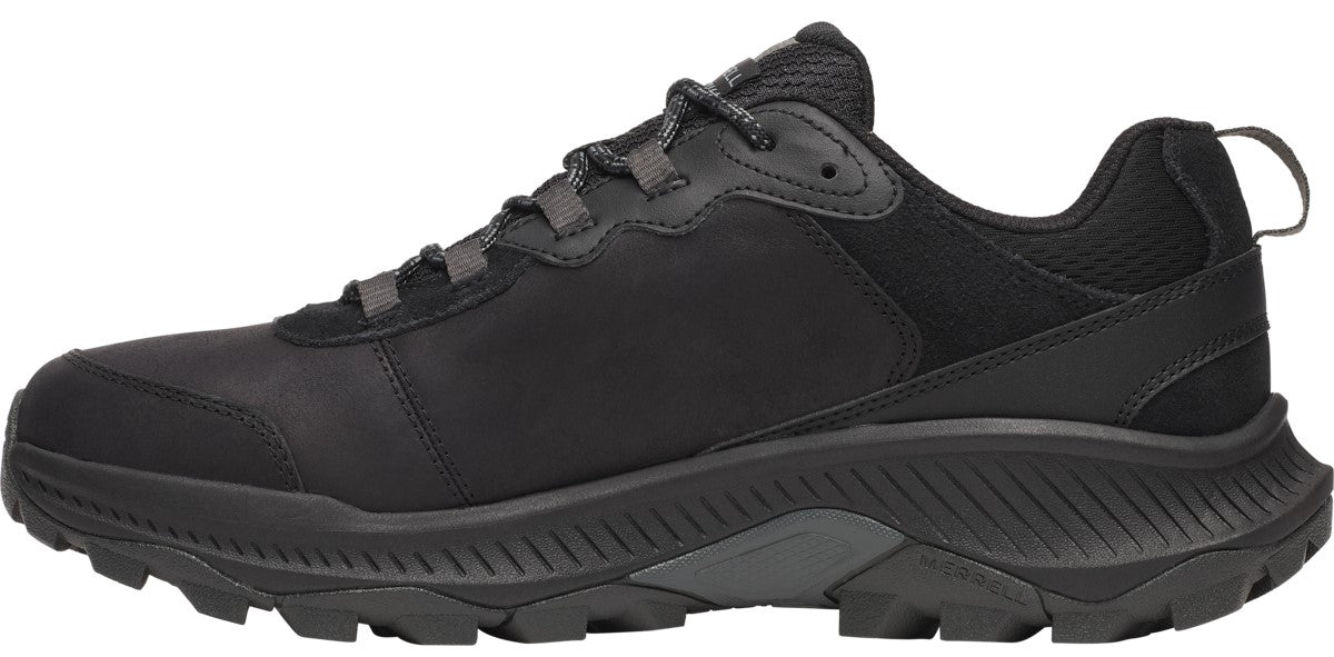 A side view of a black hiking shoe with a lace-up closure and a thick lug sole.
