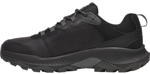 A side view of a black hiking shoe with a lace-up closure and a thick lug sole.