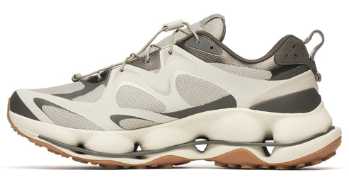 Tan and gray sneaker with toggle lacing, and stacked rounded white sole on brown tread.