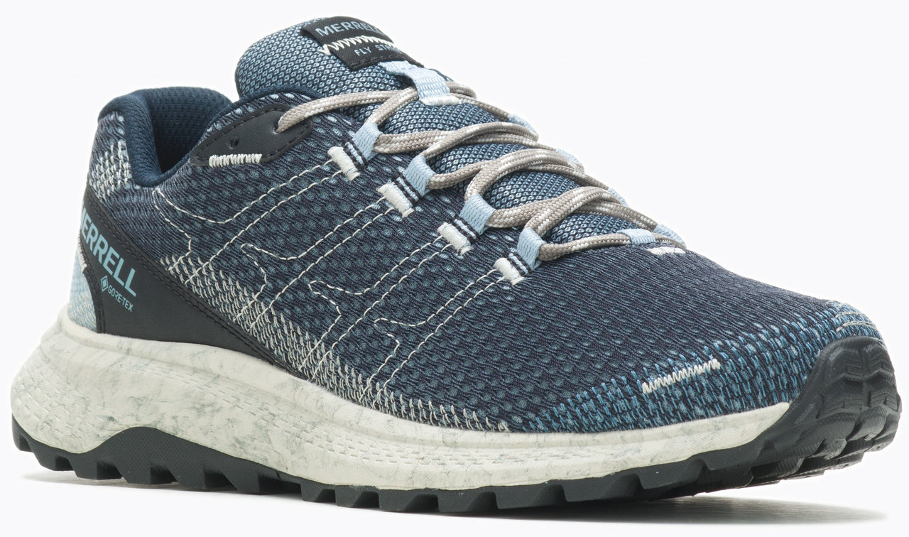 Low top athletic shoe with a blue upper, gray laces, speckled white midsole, and black lug outsole.