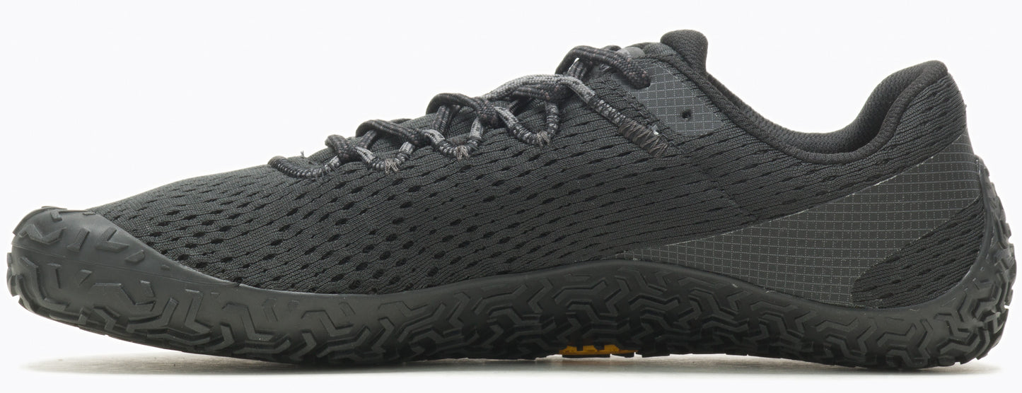 A black athletic shoe with a low profile and a patterned sole.