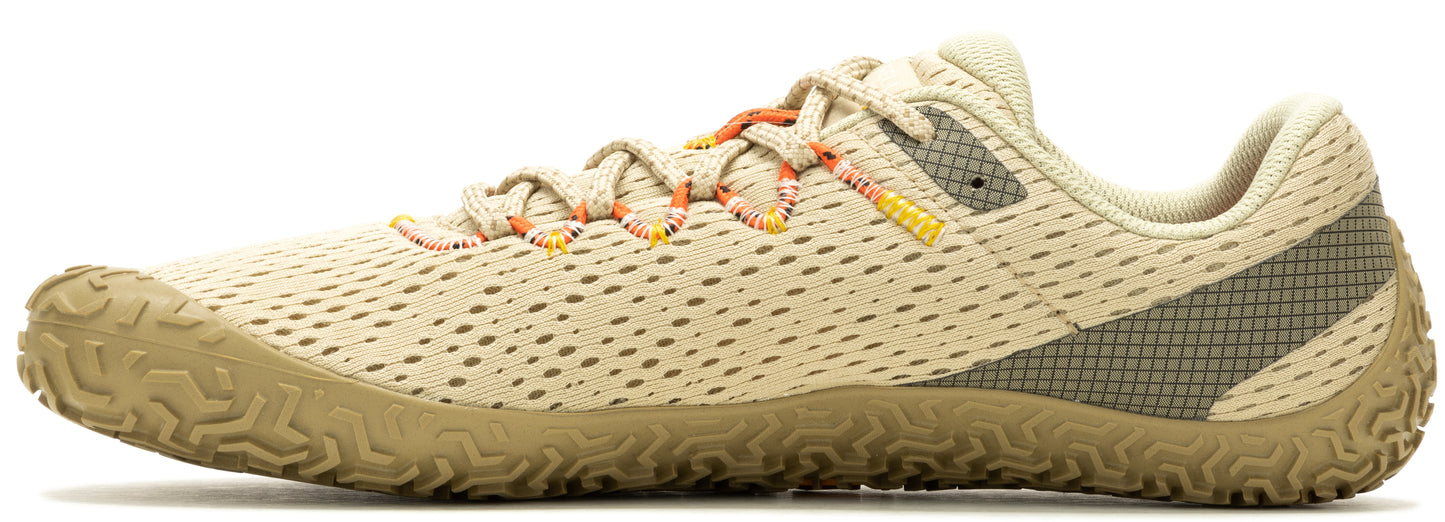 A tan sneaker with orange laces and a brown sole.