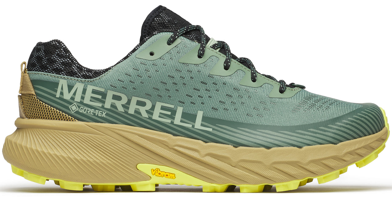 A low-top athletic shoe with a green perforated upper, black patterned collar, and a yellow and tan jagged sole; "MERRELL" and "GORE-TEX" are printed on the side.