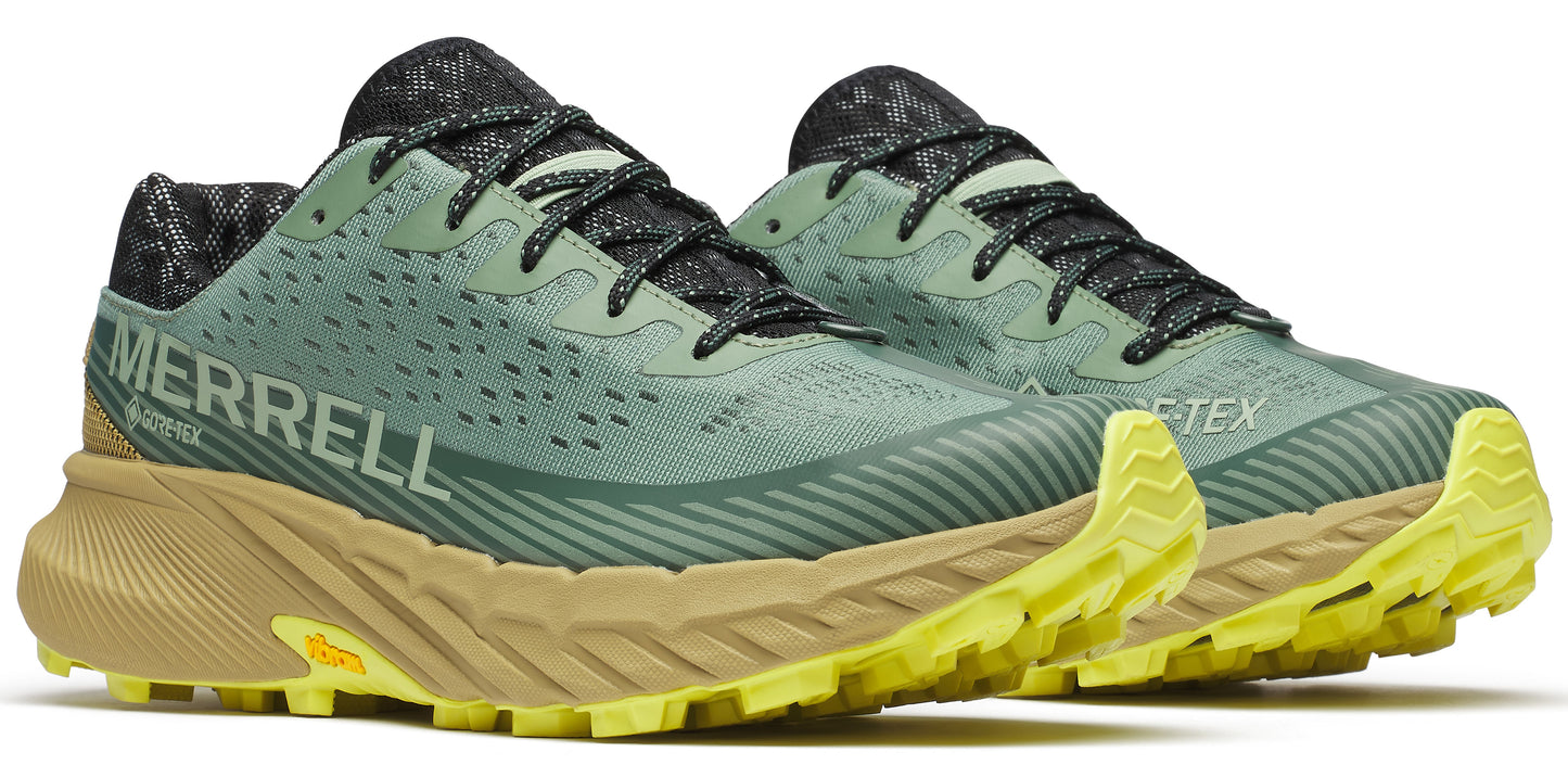 Pair of trail running shoes in light green with a patterned black interior and laces, featuring a thick light brown and yellow sole, and the word MERRELL printed on the side.