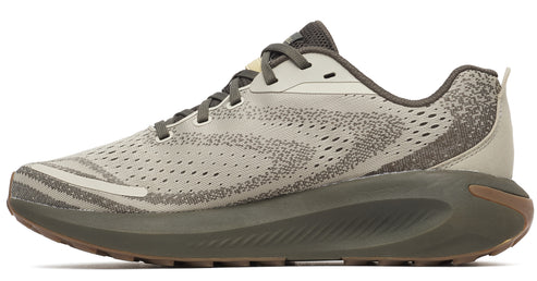 Side view of a speckled beige running shoe with a thick, gray-green sole and brown-tread bottom.