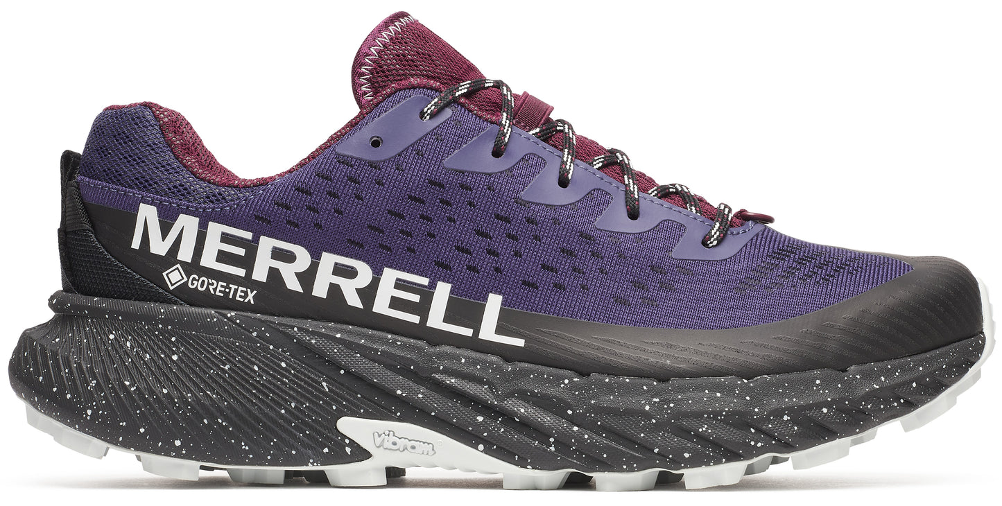 A purple running shoe with a black midsole speckled with white, and white "vibram" text on the sole. The word "MERRELL" with "GORE-TEX" text appears in white on the side of the shoe.