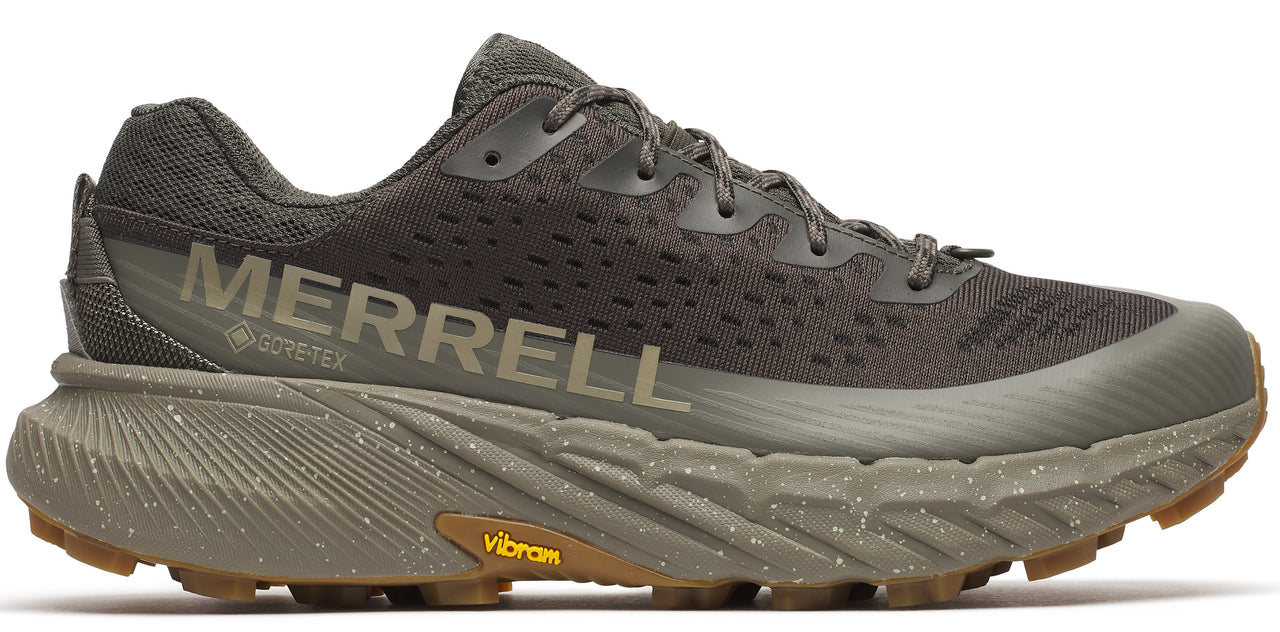 A hiking shoe in dark green with the word MERRELL printed on the side.