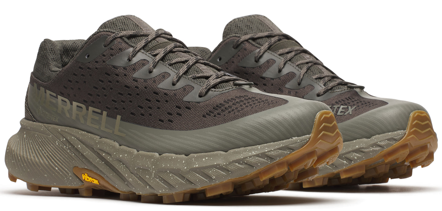A pair of olive-green running shoes with the word MERRELL on the side and a brown sole.