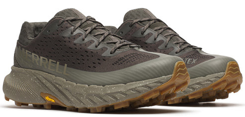 A pair of olive-green running shoes with the word MERRELL on the side and a brown sole.