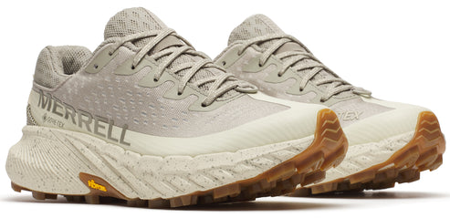 Two athletic shoes with GORE-TEX and Vibram labels, featuring speckled midsoles and lugged outsoles.