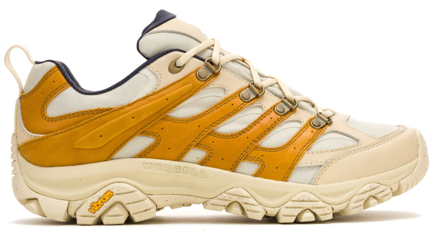Tan and mustard-colored athletic shoe with Vibram sole and d-ring laces.