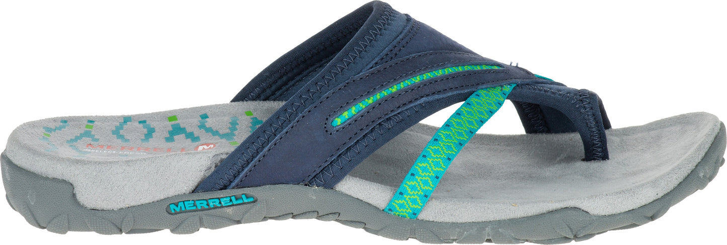 A navy and green thong sandal on a gray sole.