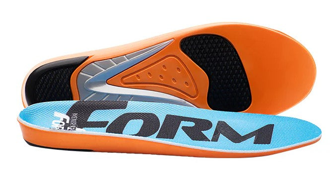 A pair of orange and light blue shoe insoles, with the top insole displaying the text FORM in large black letters and the bottom insole showing the textured support structure of the underside.