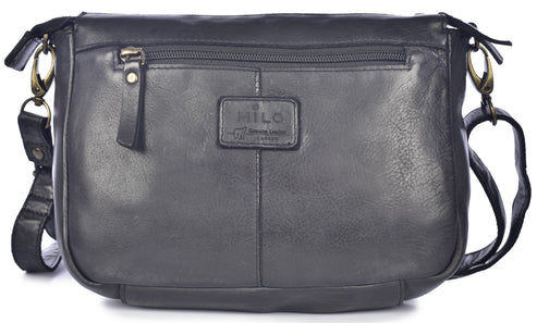 A black leather crossbody bag featuring a front zippered pocket with a leather pull tab, a rectangular brand patch centered on the front, and adjustable shoulder straps attached with brass-toned metal clasps.