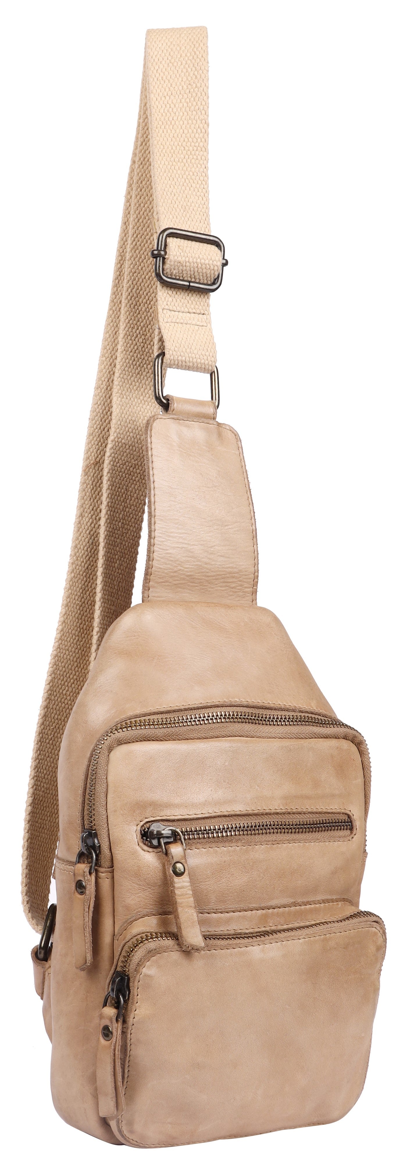 A tan, vertical, soft leather crossbody sling bag with an adjustable shoulder strap featuring silver-toned hardware, multiple zippered compartments, and pull tabs.