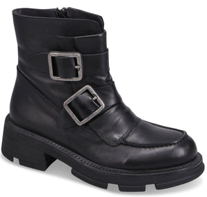 Black ankle boot with two decorative straps and silver buckles, lug sole.
