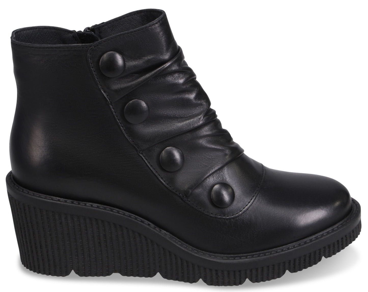 A black leather wedge-heeled ankle boot with a rounded toe, a side zipper, and a decorative panel featuring four matching black buttons, set against a black, heavily ridged wedge sole.