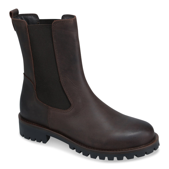 A dark brown leather Chelsea boot with a thick black lug sole.