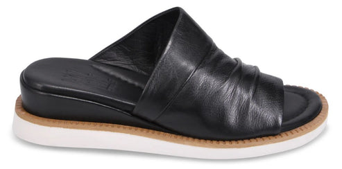 Black leather slide with a ruched upper and white sole.