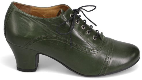 A dark olive green vintage-style oxford heel with decorative brogue detailing on the side and toe, featuring a lace-up front with black laces and a mid-height block heel.