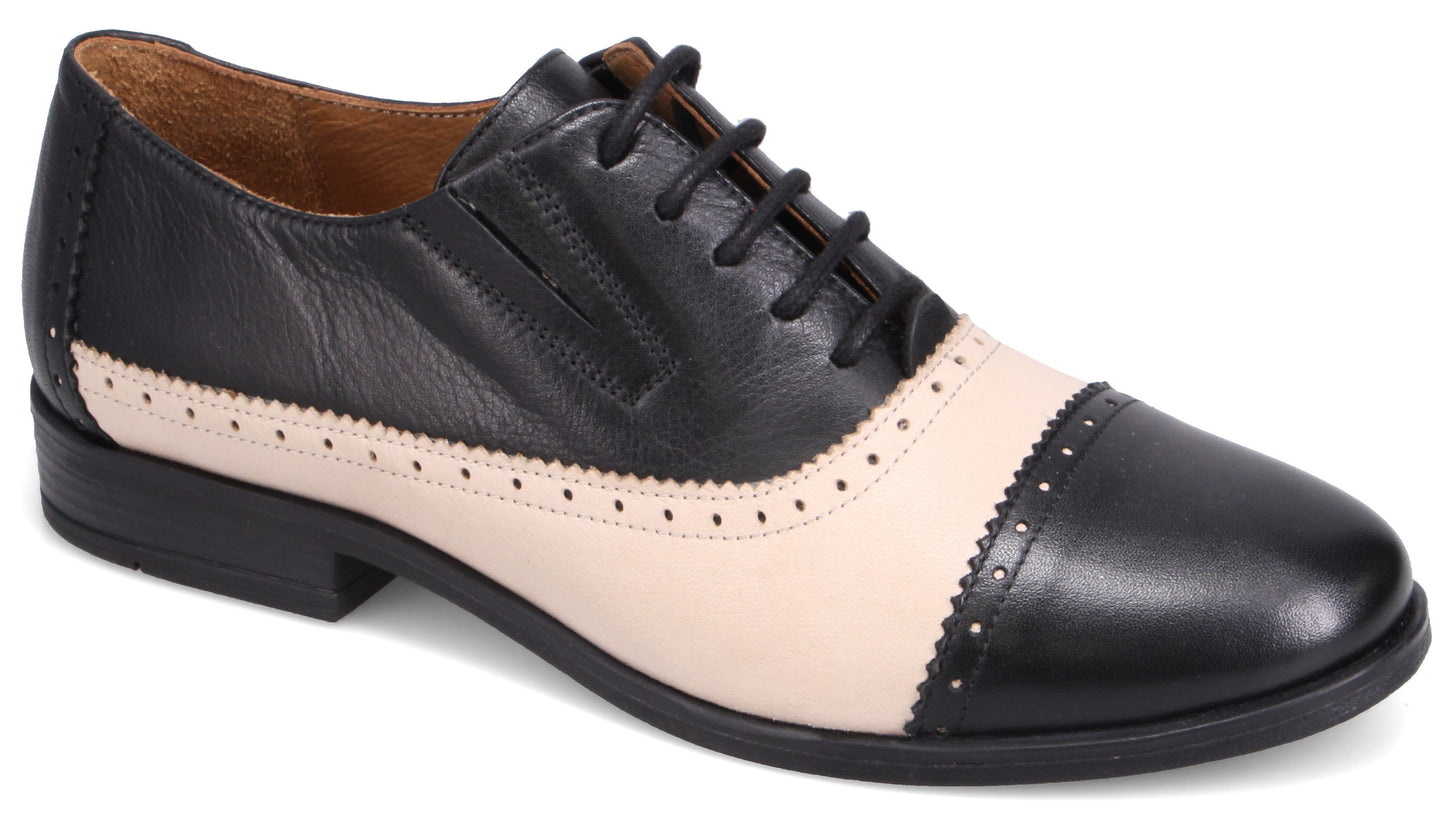 Black and cream leather cap-toe Oxford shoe.