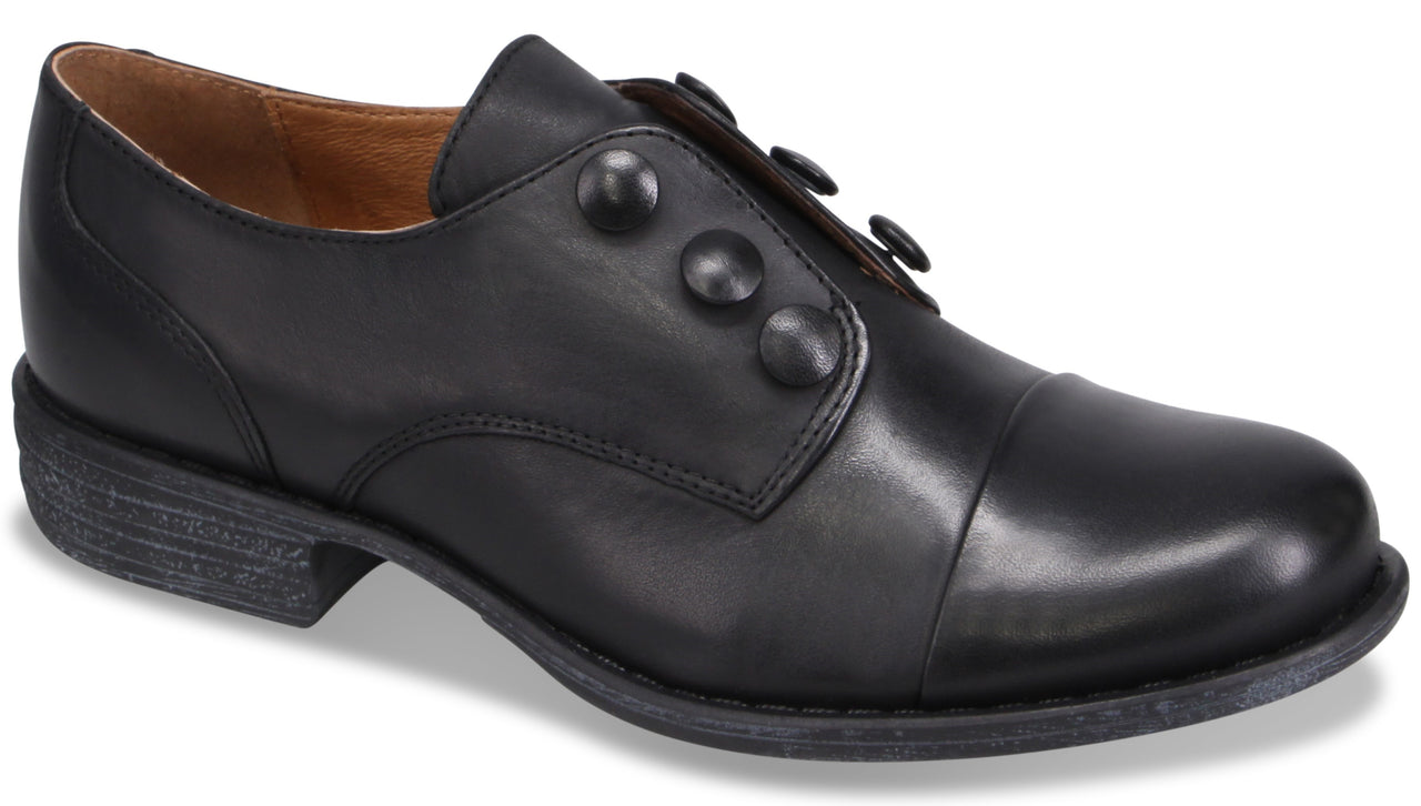 A black leather oxford-style dress shoe with a rounded toe, a low stacked heel, and three circular decorative buttons along the top panel.