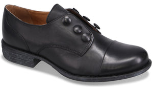 A black leather oxford-style dress shoe with a rounded toe, a low stacked heel, and three circular decorative buttons along the top panel.