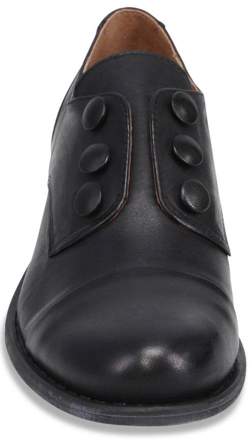 A black leather shoe shown from a front-facing perspective, featuring a rounded toe and three decorative buttons on each side of the central vamp.