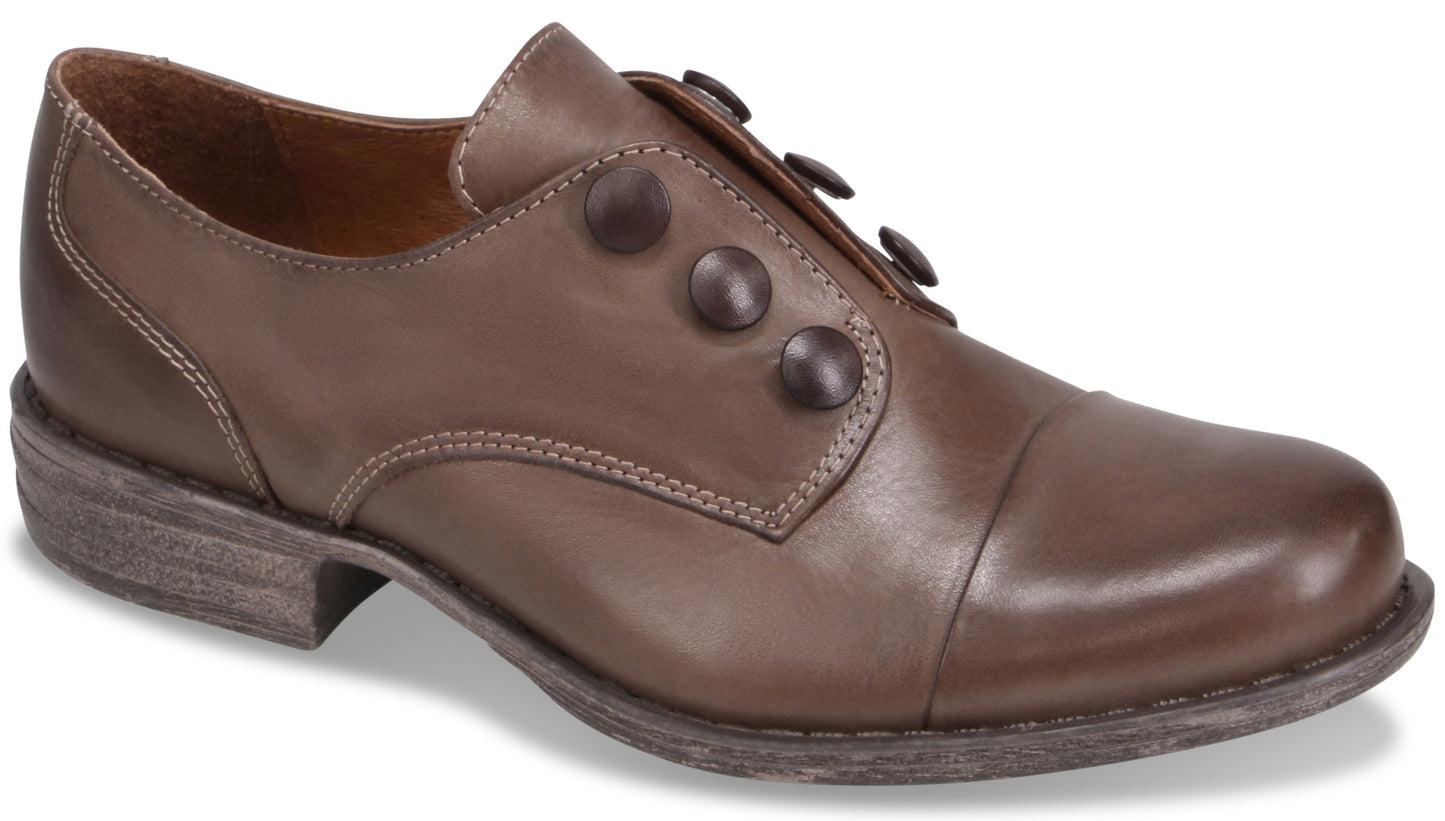 A brown leather cap-toe shoe with a low heel and three decorative buttons along the side.