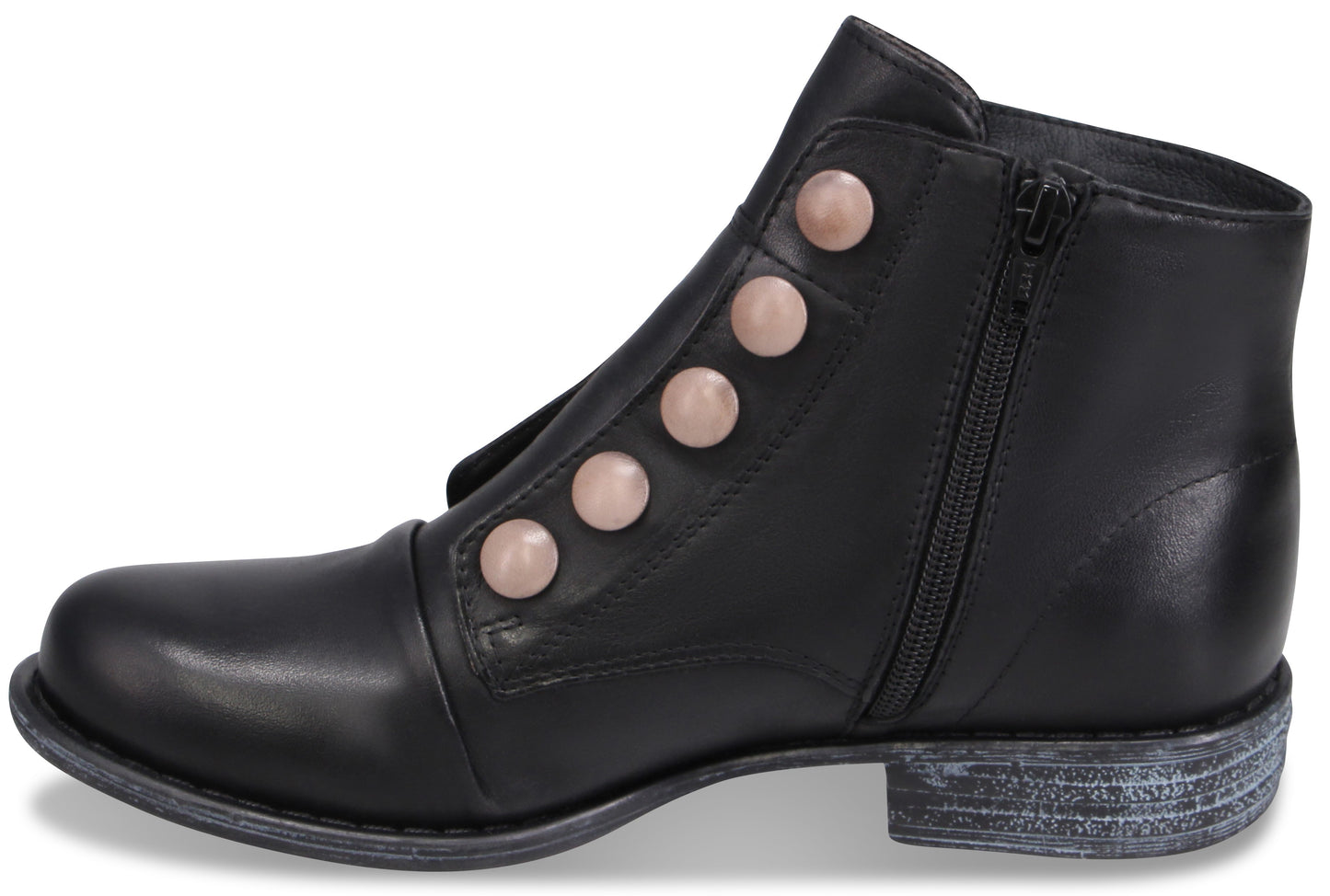 A black leather ankle boot with a rounded toe, a low distressed-look heel, a side zipper closure, and a decorative row of five pale pink circular buttons running diagonally up the instep.