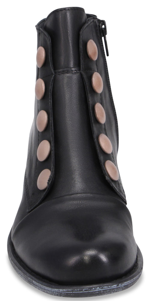 A black ankle boot with a rounded toe and a vertical row of five decorative matte rose-gold buttons on each side of the front panel, with a small zipper visible on the upper side.