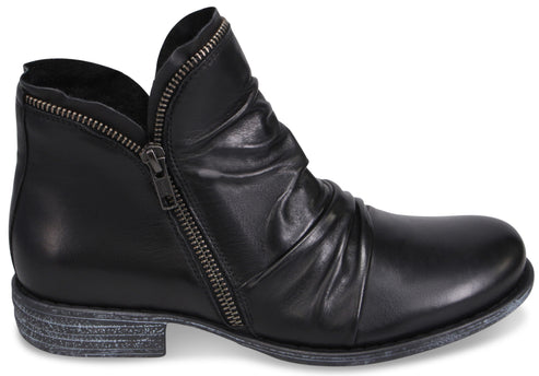 A black leather ankle boot with a side zipper and ruched detailing on the front, featuring a distressed grey textured sole.