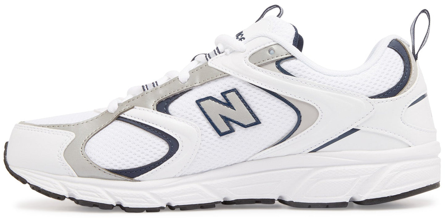 A New Balance athletic shoe in white with grey and navy accents, featuring mesh and synthetic upper, lace-up closure, and a cushioned white midsole with a grey logo N on the side.