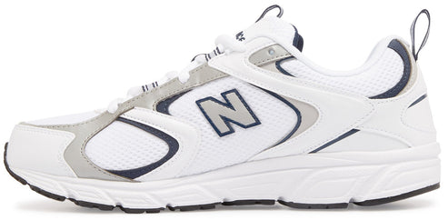 A New Balance athletic shoe in white with grey and navy accents, featuring mesh and synthetic upper, lace-up closure, and a cushioned white midsole with a grey logo N on the side.