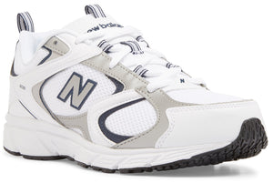 A New Balance 608 athletic sneaker in white with grey and navy blue accents, featuring a prominent N logo on the side, mesh detailing, and a chunky white midsole with a black rubber outsole.